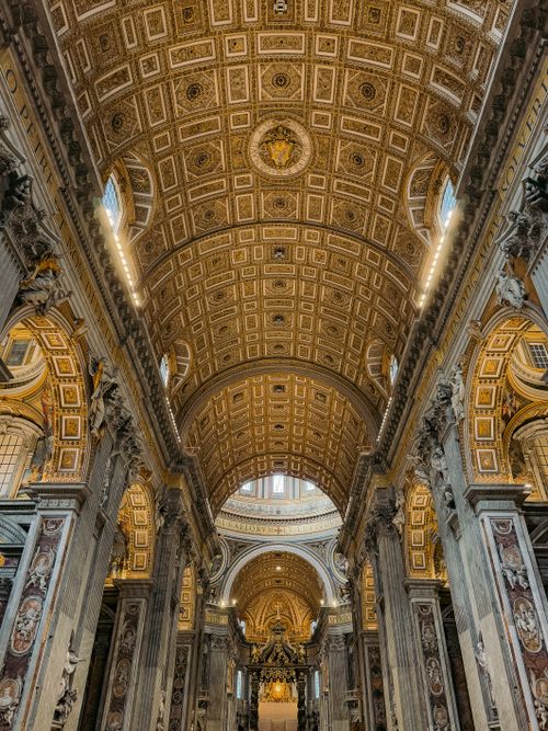 Free Intricate architectural details of St. Peter's Basilica's interior, showcasing ornate designs and grandeur. Stock Photo