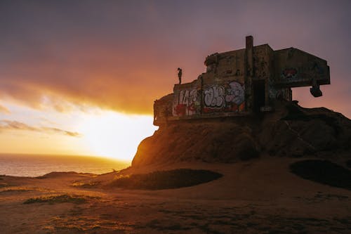 Two Men Standing On Abandoned Structure