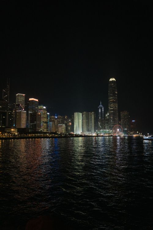 Free Beautiful night view of Hong Kong skyline with city lights reflecting on water. Stock Photo