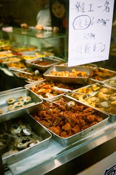 Vibrant display of Asian street food with various dishes in a bustling market setting.