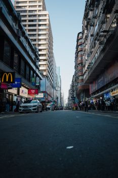 Vibrant city street with bustling crowds and towering buildings, ideal for urban lifestyle themes.