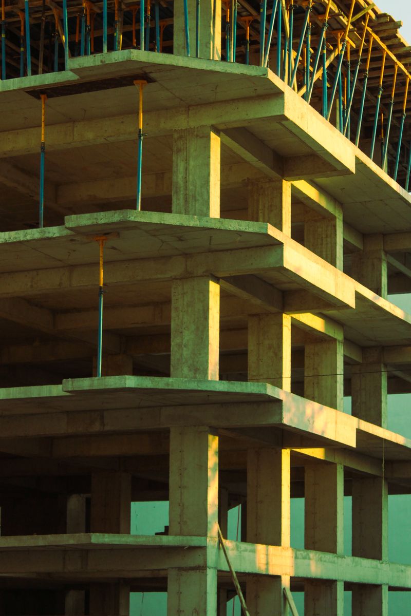 Concrete building structure in early stages of construction captured at sunset