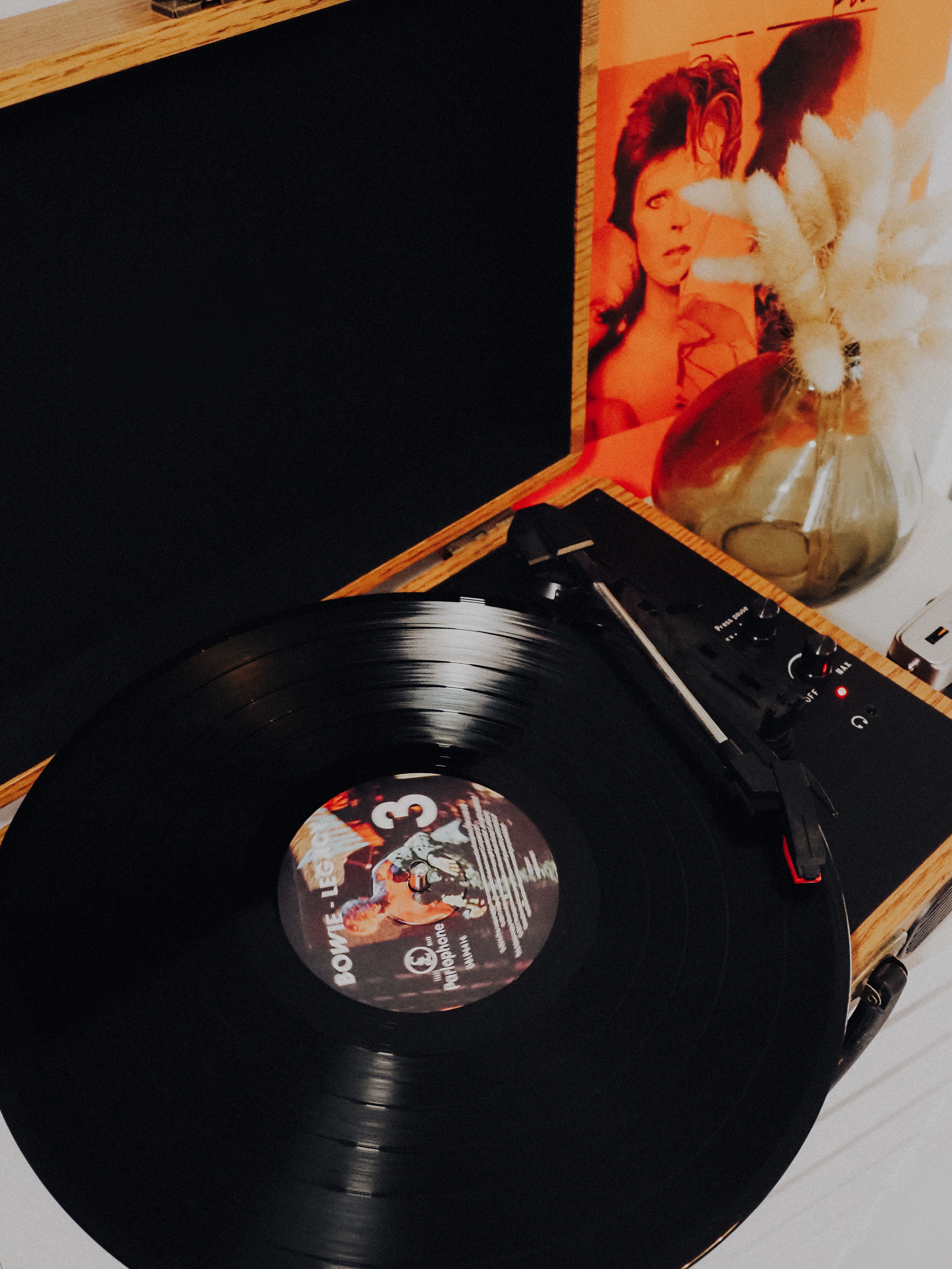 Vinyl record with album cover displayed on black surface`