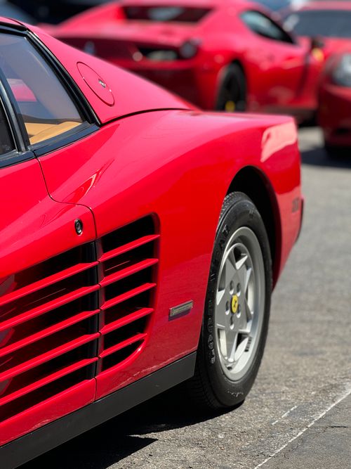 Free Detailed view of a red Ferrari Testarossa parked outdoors with other sports cars in Los Angeles. Stock Photo