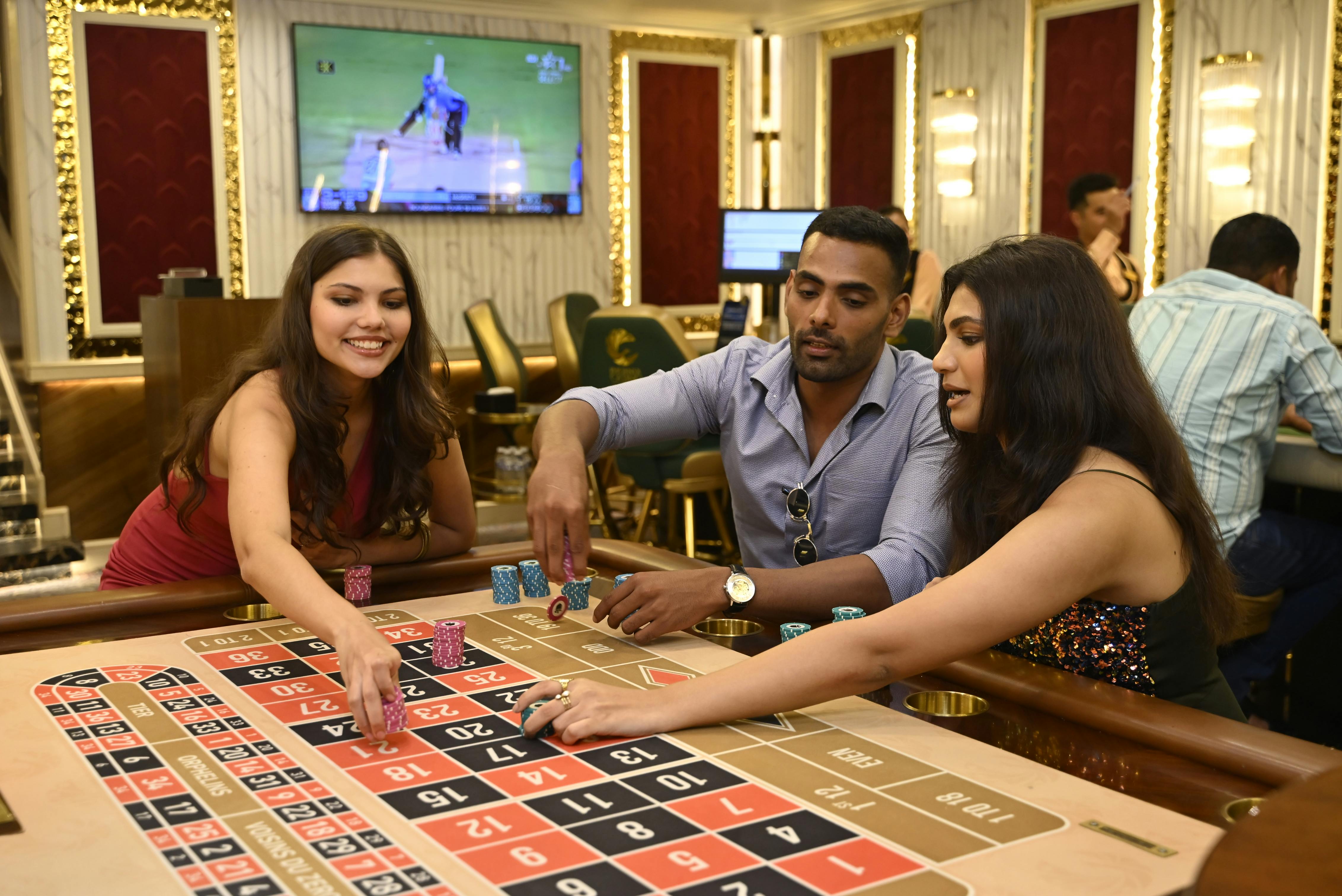 Group of adults enjoying a night of gambling at a casino in Candolim, Goa.