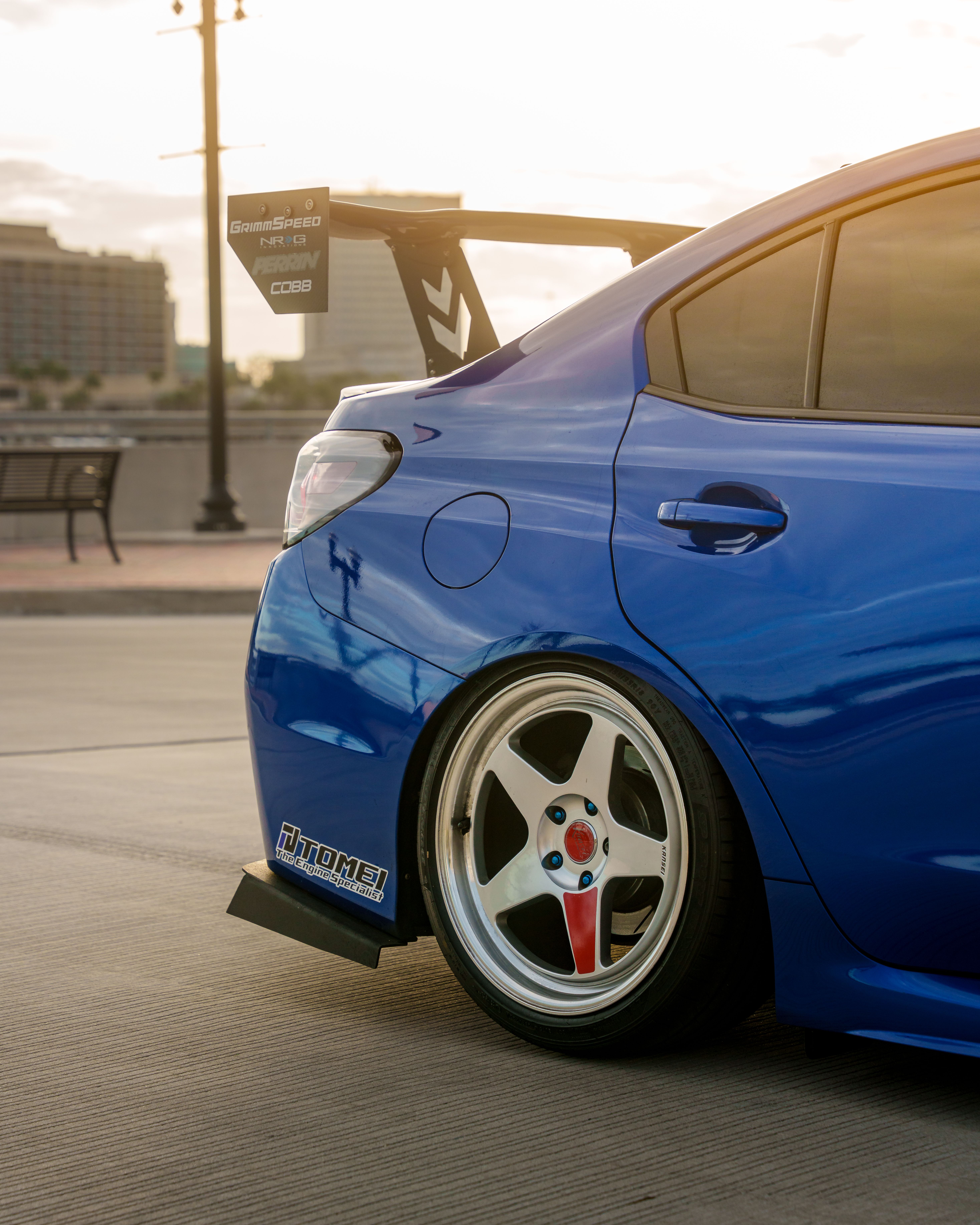 Sleek Blue Racing Car with Rear Spoiler at Sunset · Free Stock Photo