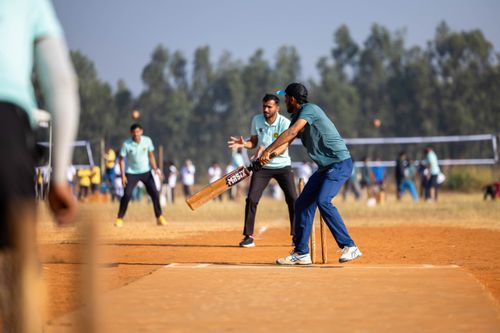 Free Dynamic scene of a cricket match capturing the batsman in action on an outdoor field. Stock Photo