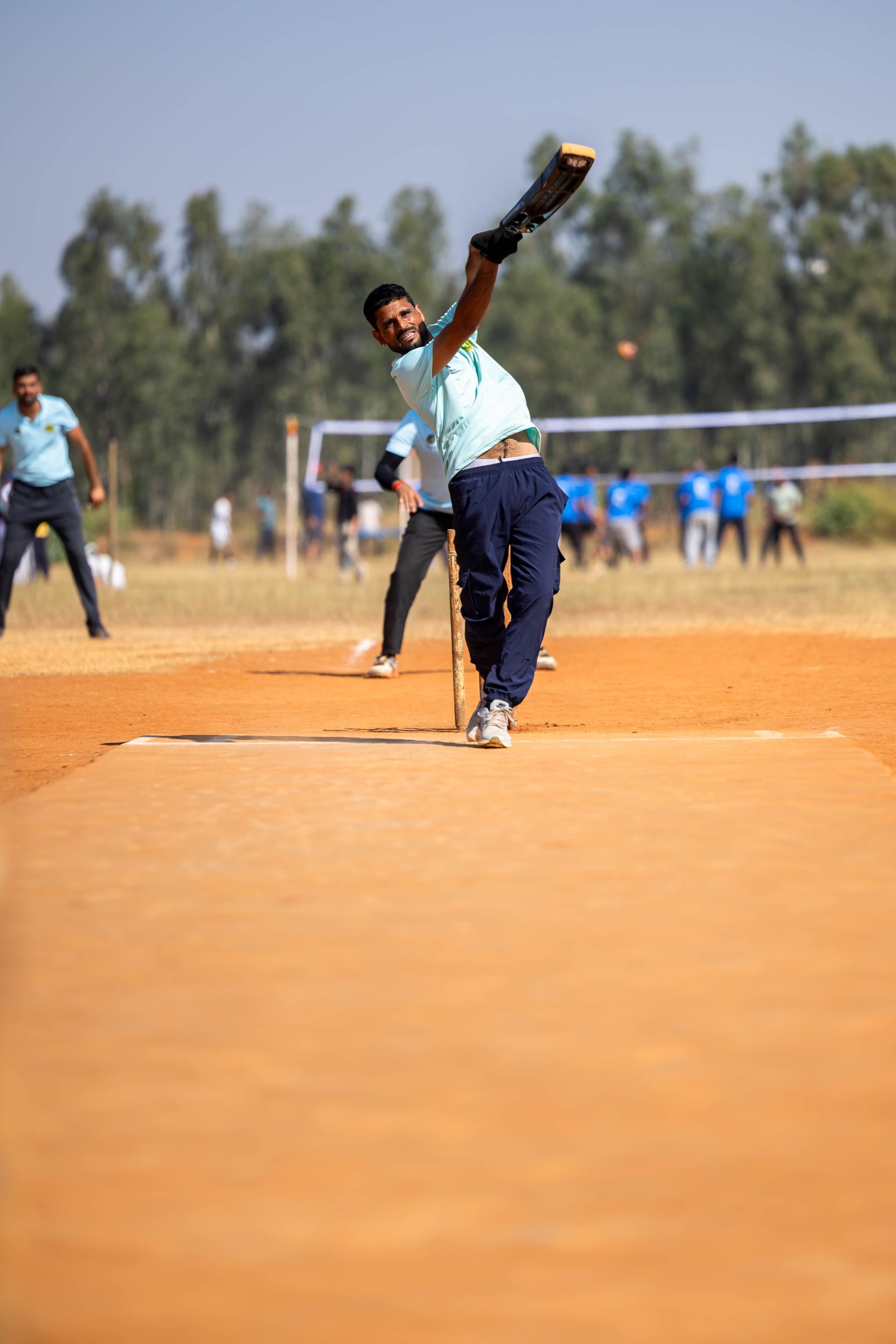 A bowler in his delivery stride