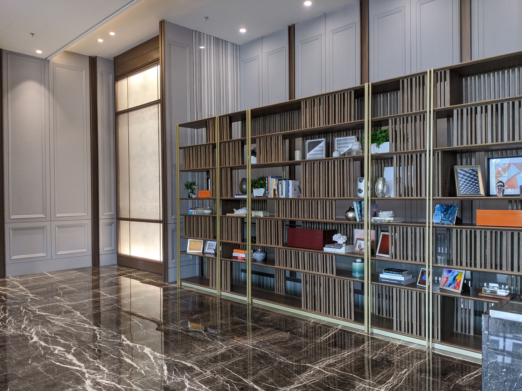 Elegant luxury interior with wooden shelving and marble flooring, perfect for decoration inspiration.