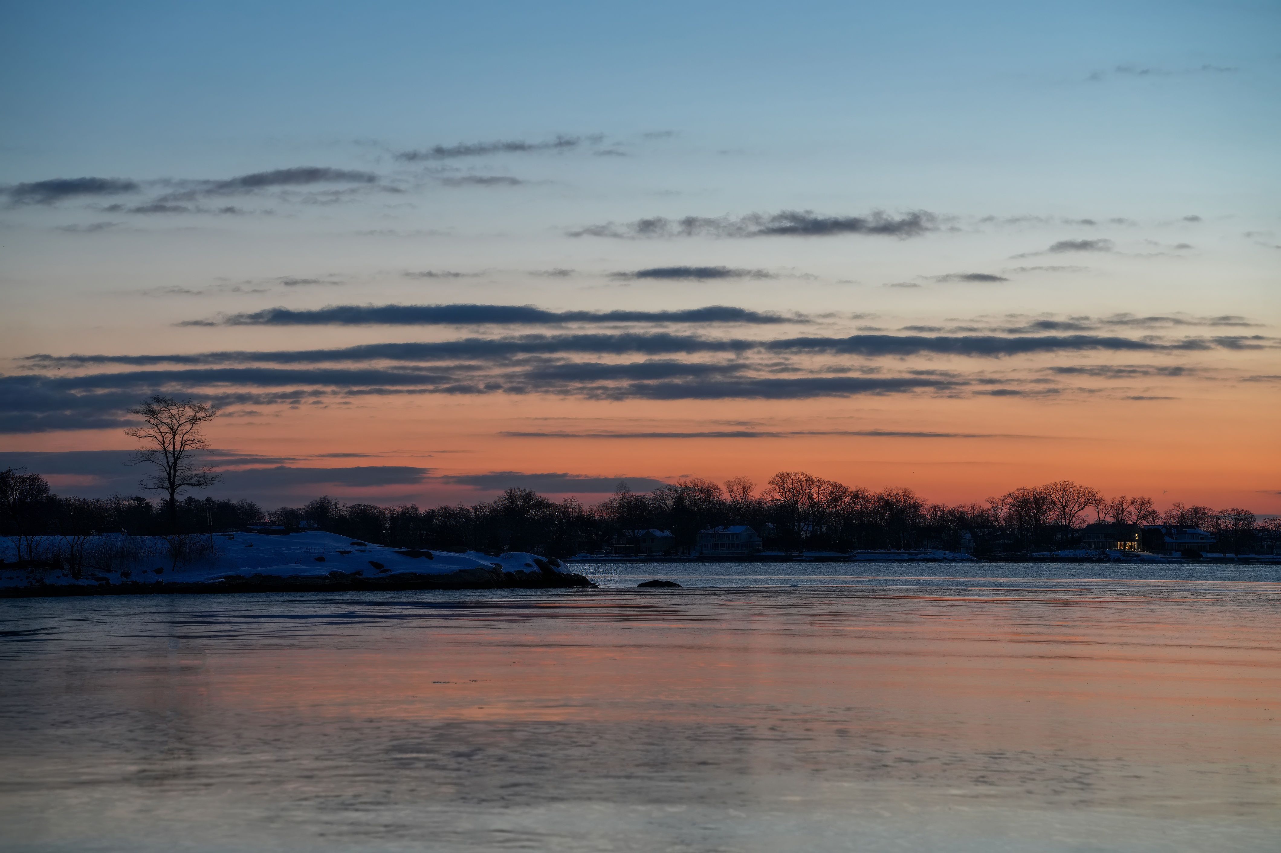 Serene Winter Sunset Over Frozen Lake · Free Stock Photo
