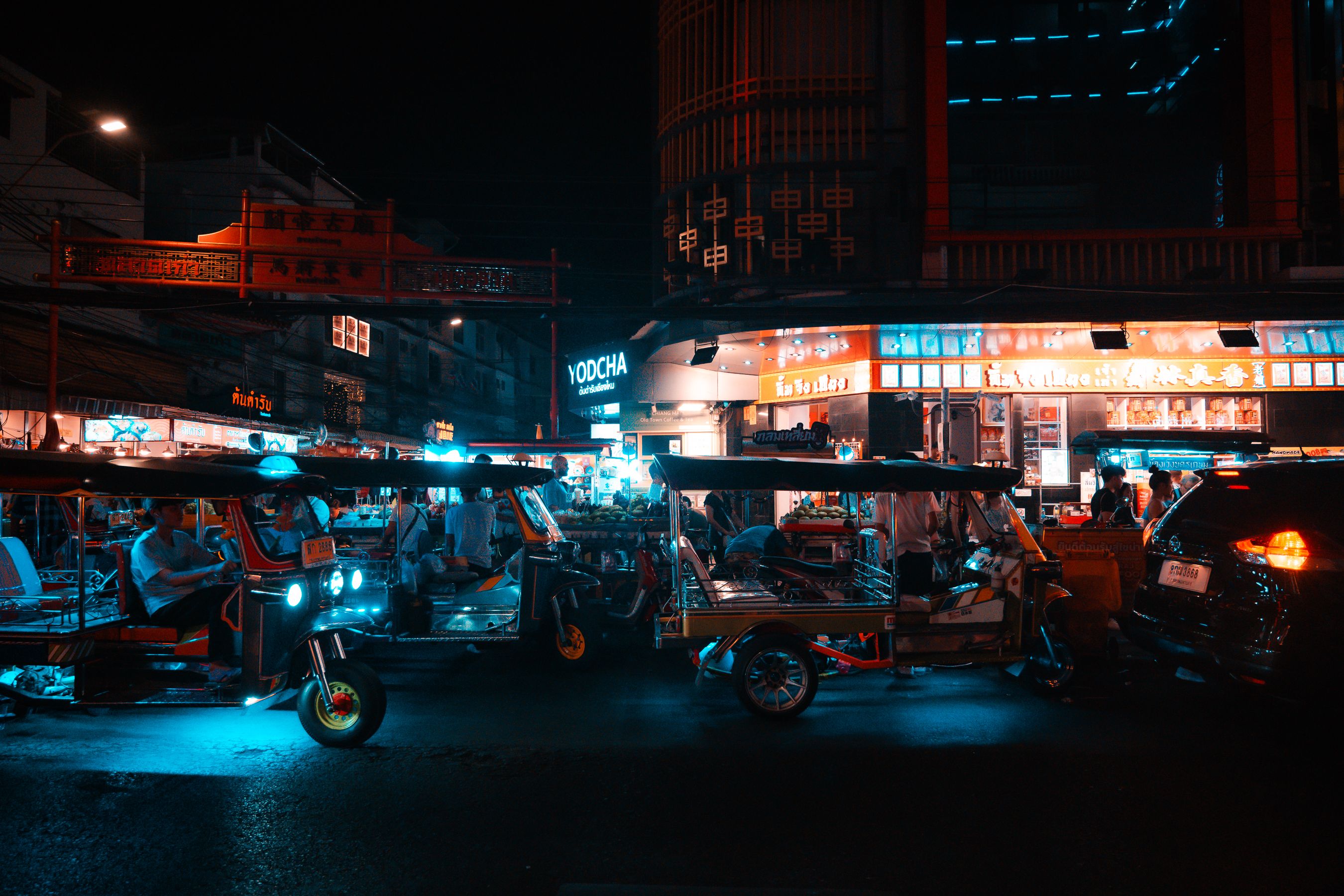 A traditional tuk-tuk driving through a street in Siem Reap, Cambodia