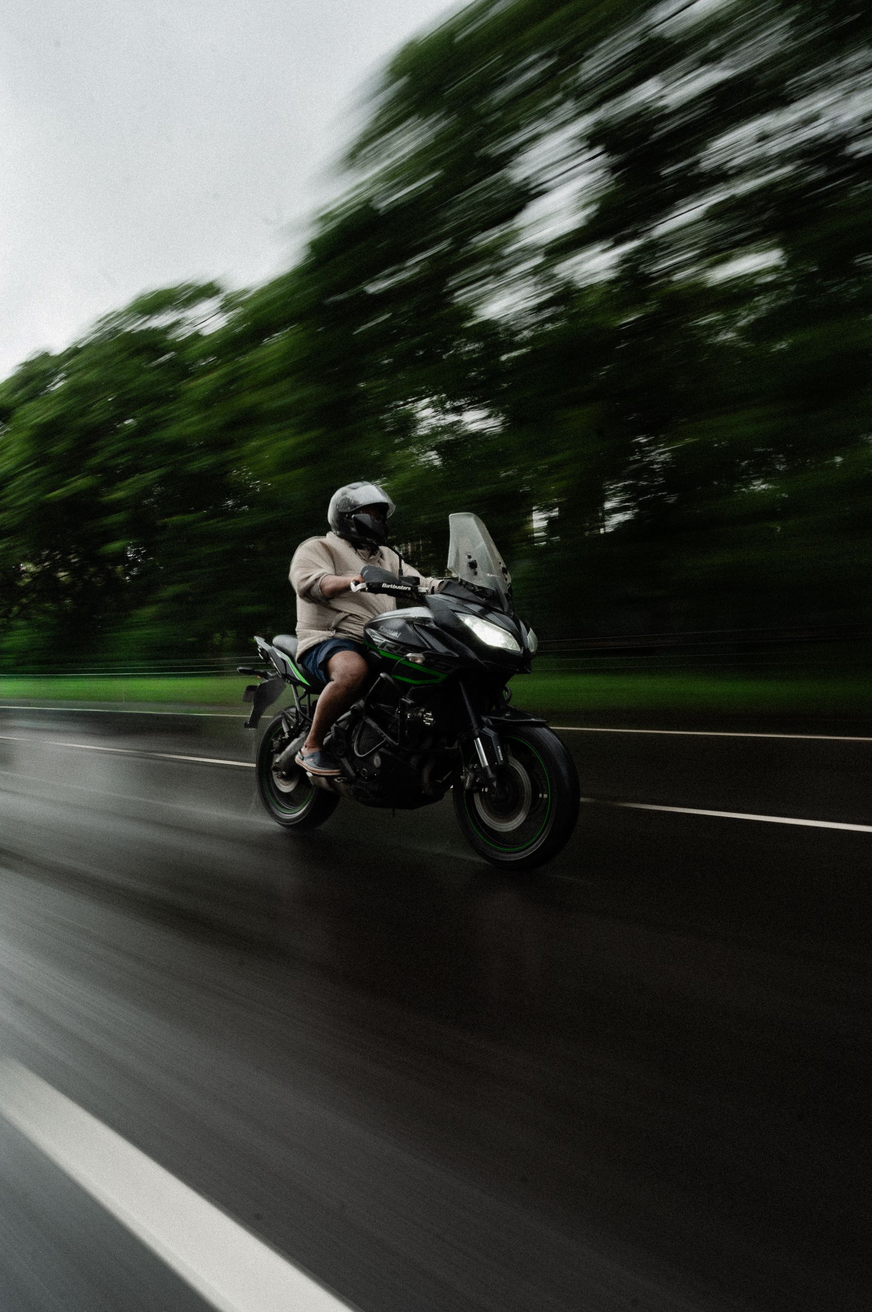 Motorcyclist on Kawasaki Riding Through Rainy Mumbai · Free Stock Photo