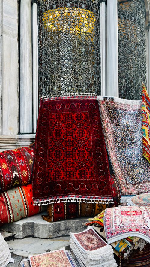 Free A captivating assortment of colorful Turkish rugs displayed outdoors, showcasing intricate designs and patterns. Stock Photo