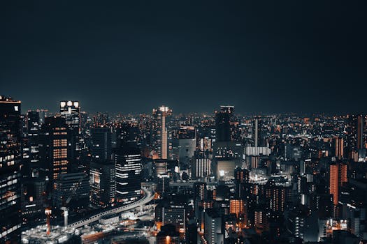 A captivating nighttime cityscape showcasing a vibrant urban skyline with illuminated buildings.