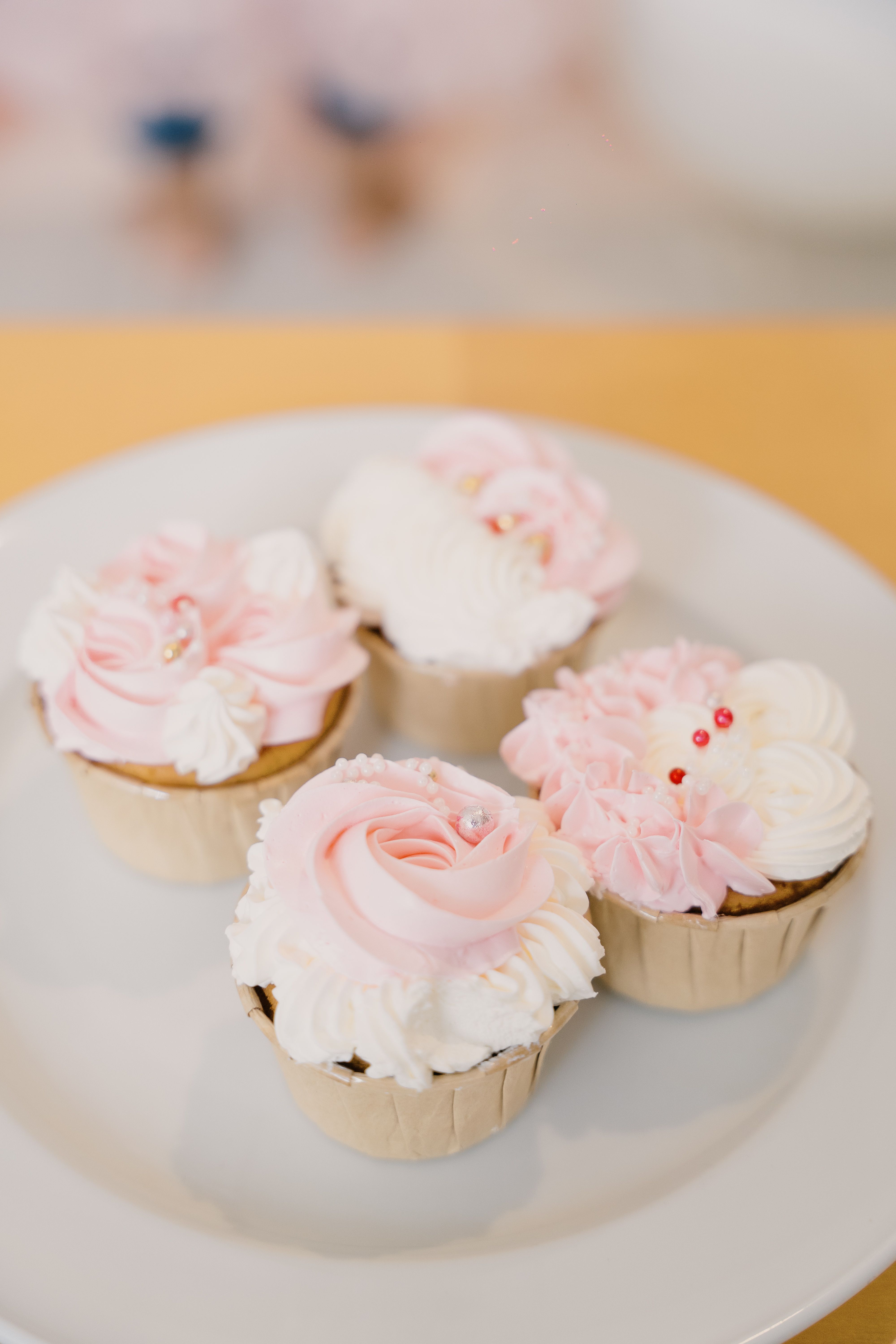 Delicate pink and white floral cupcakes perfect for celebrations or special occasions.