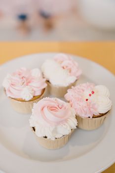 Delicate pink and white floral cupcakes perfect for celebrations or special occasions.