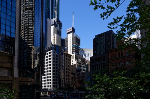 Free A vibrant cityscape showcasing towering skyscrapers against a clear blue sky. Stock Photo