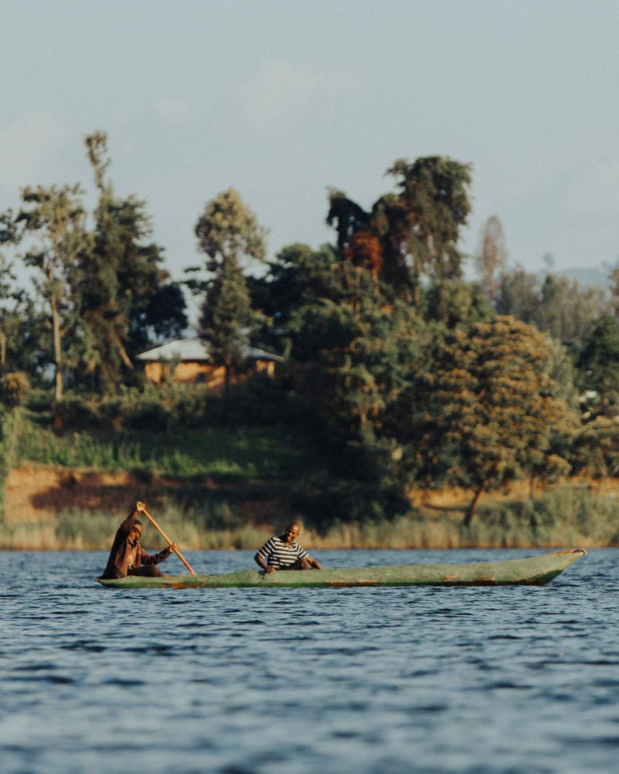 Canoe on Lake Bunyonyi with terraced green hills in the background, Uganda