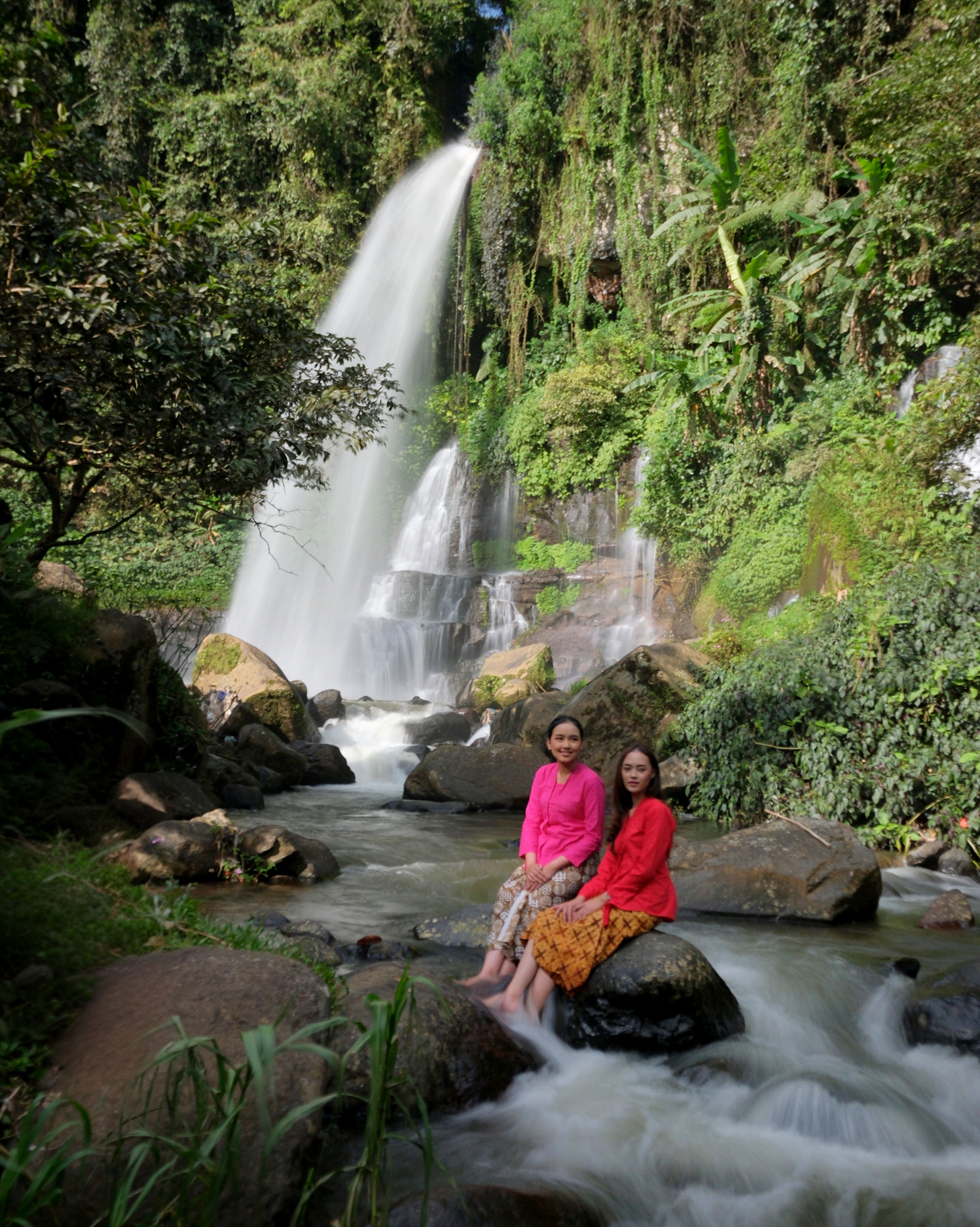 Women in Traditional Dress by Indonesian Waterfall