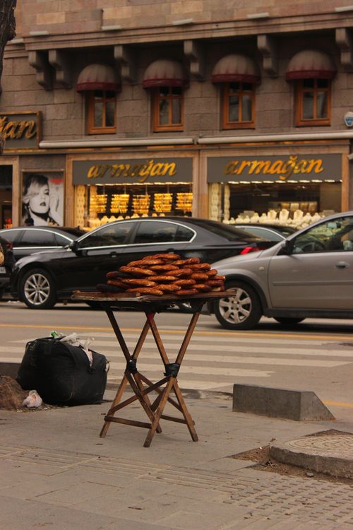 Free Simit pastry stall on a bustling city street, showcasing urban life. Stock Photo