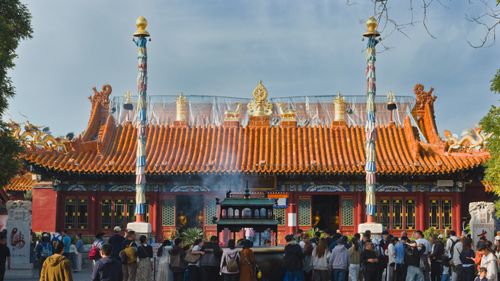 Free A vibrant temple in Hohhot, Inner Mongolia with visitors gathered for prayer. Stock Photo