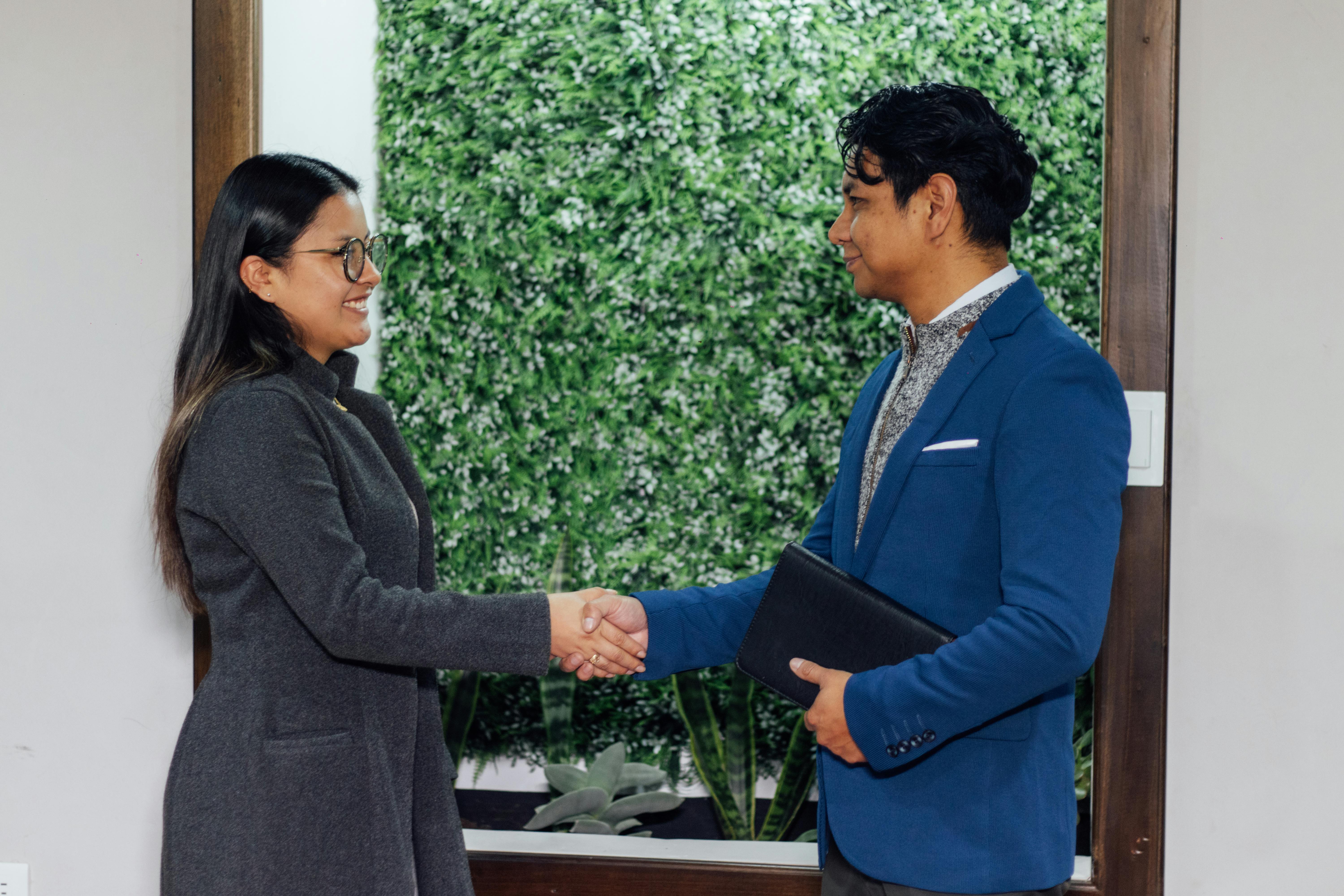 Two professionals shaking hands after a successful business agreement