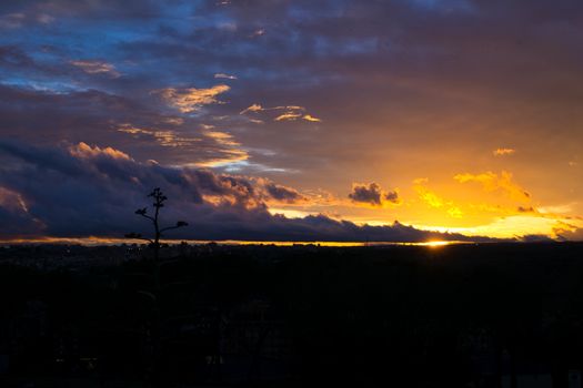 A stunning sunset with dramatic clouds and vibrant colors filling the sky.