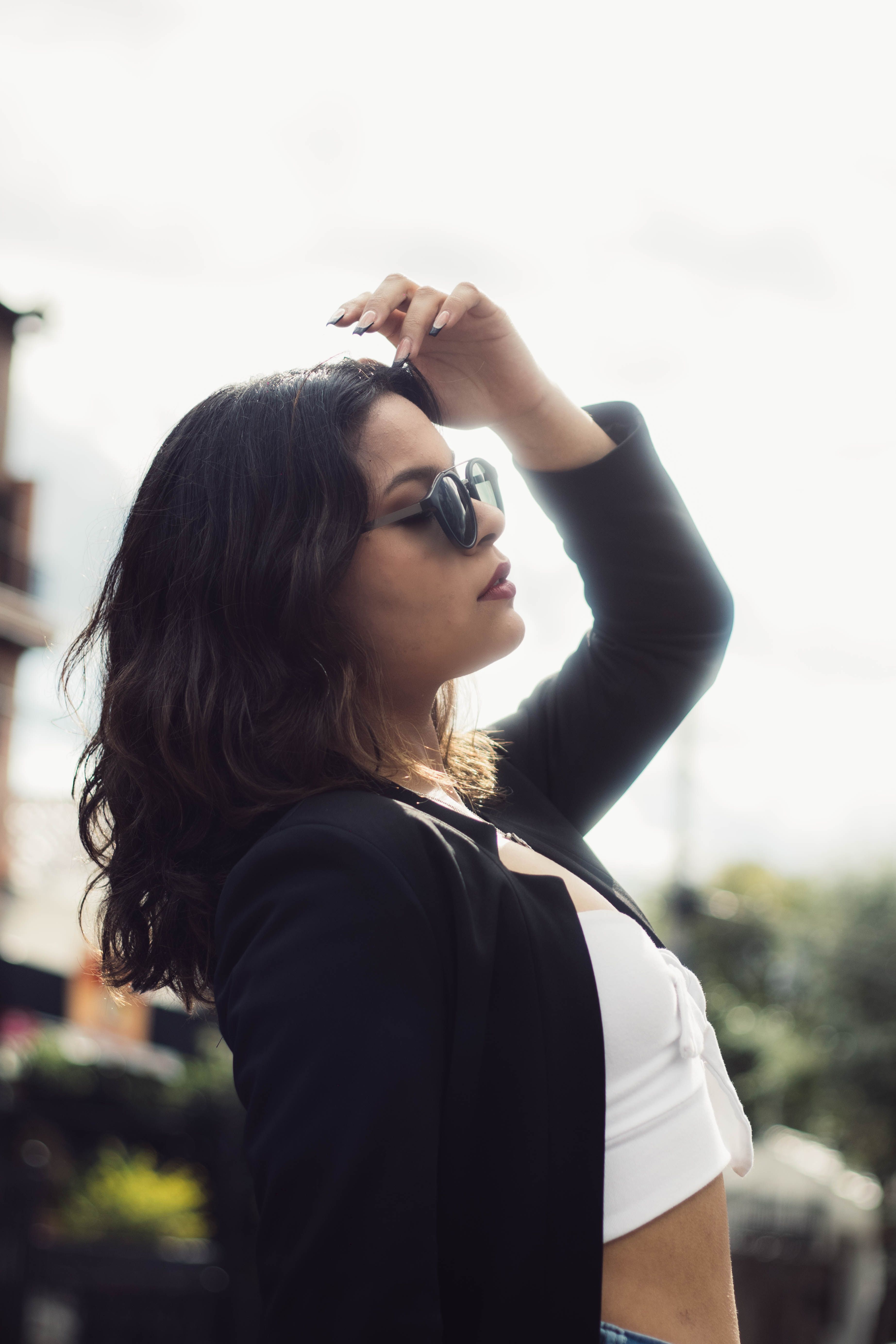 Stylish Woman in Sunglasses Posing Outdoors · Free Stock Photo