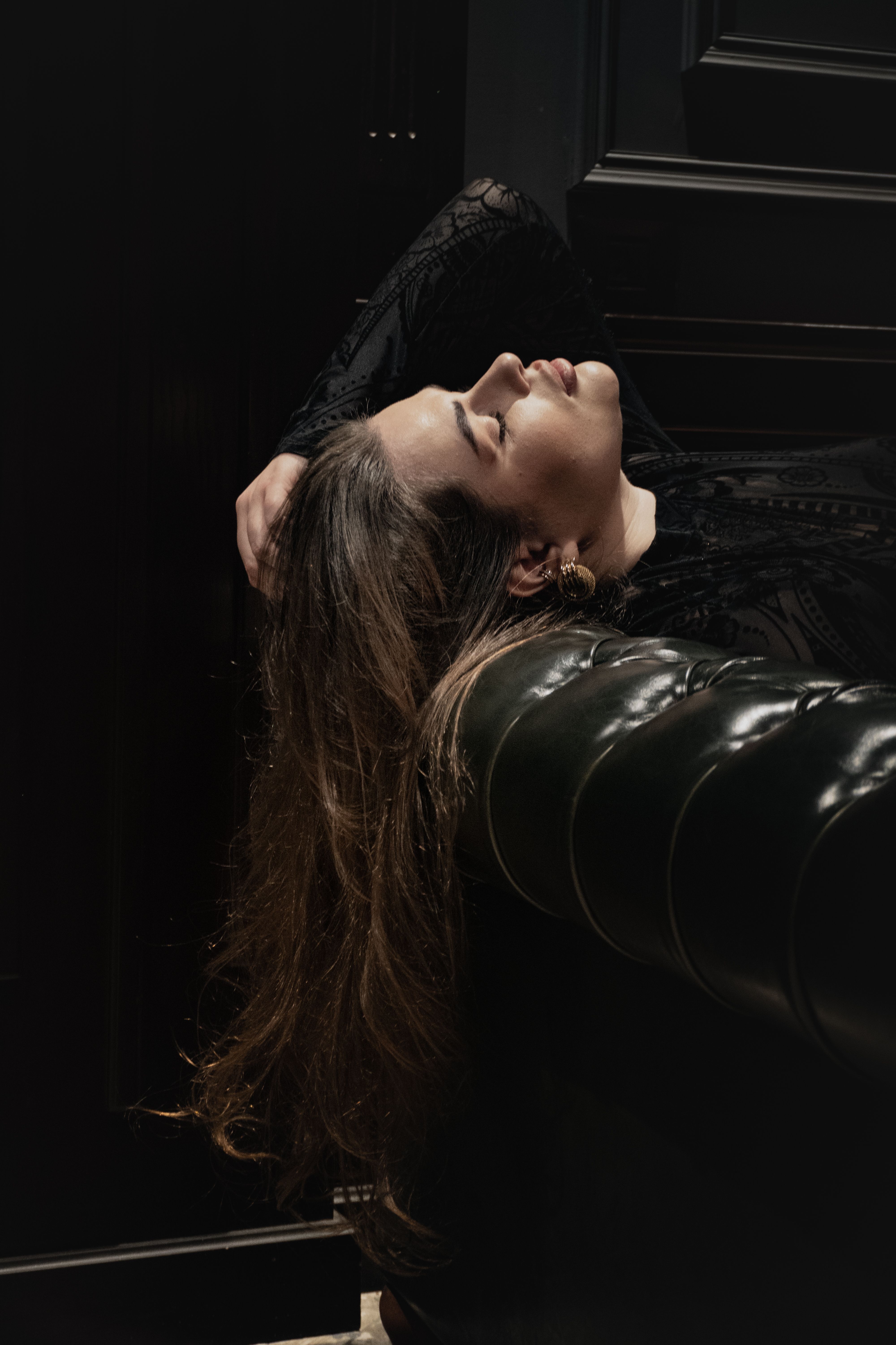 Elegant Woman in Dark Interior Setting · Free Stock Photo