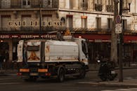 Parisian Street with Sanitation Truck and Cafe