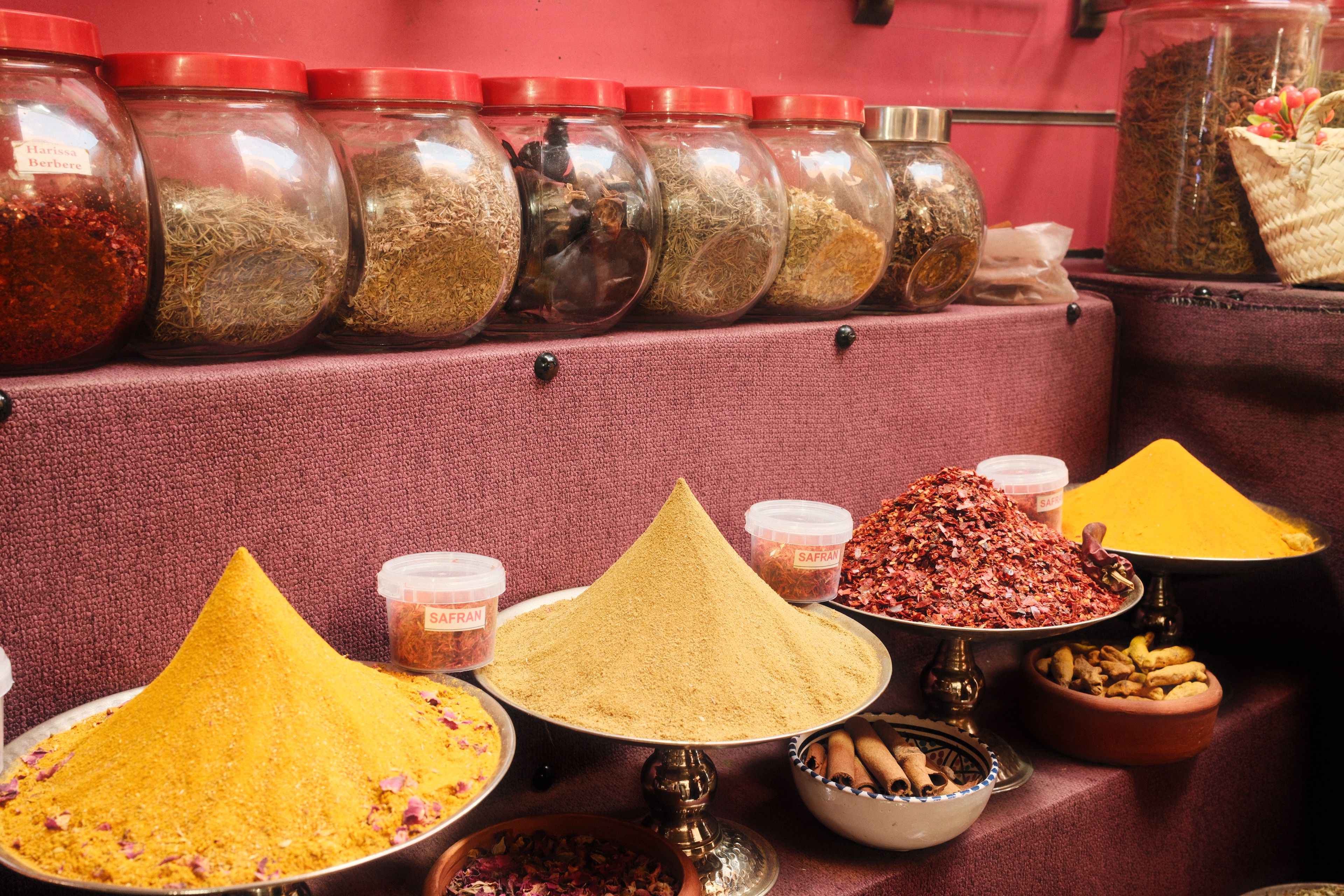 Colorful array of spices displayed in traditional market in Tunis, showcasing Tunisian culture.