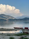 Serene Mountain Lake with Boats at Shoreline