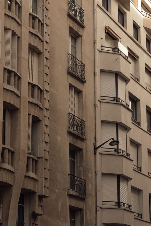 Free Classic Haussmann-style building in Paris with ornate balconies and stone facade. Stock Photo