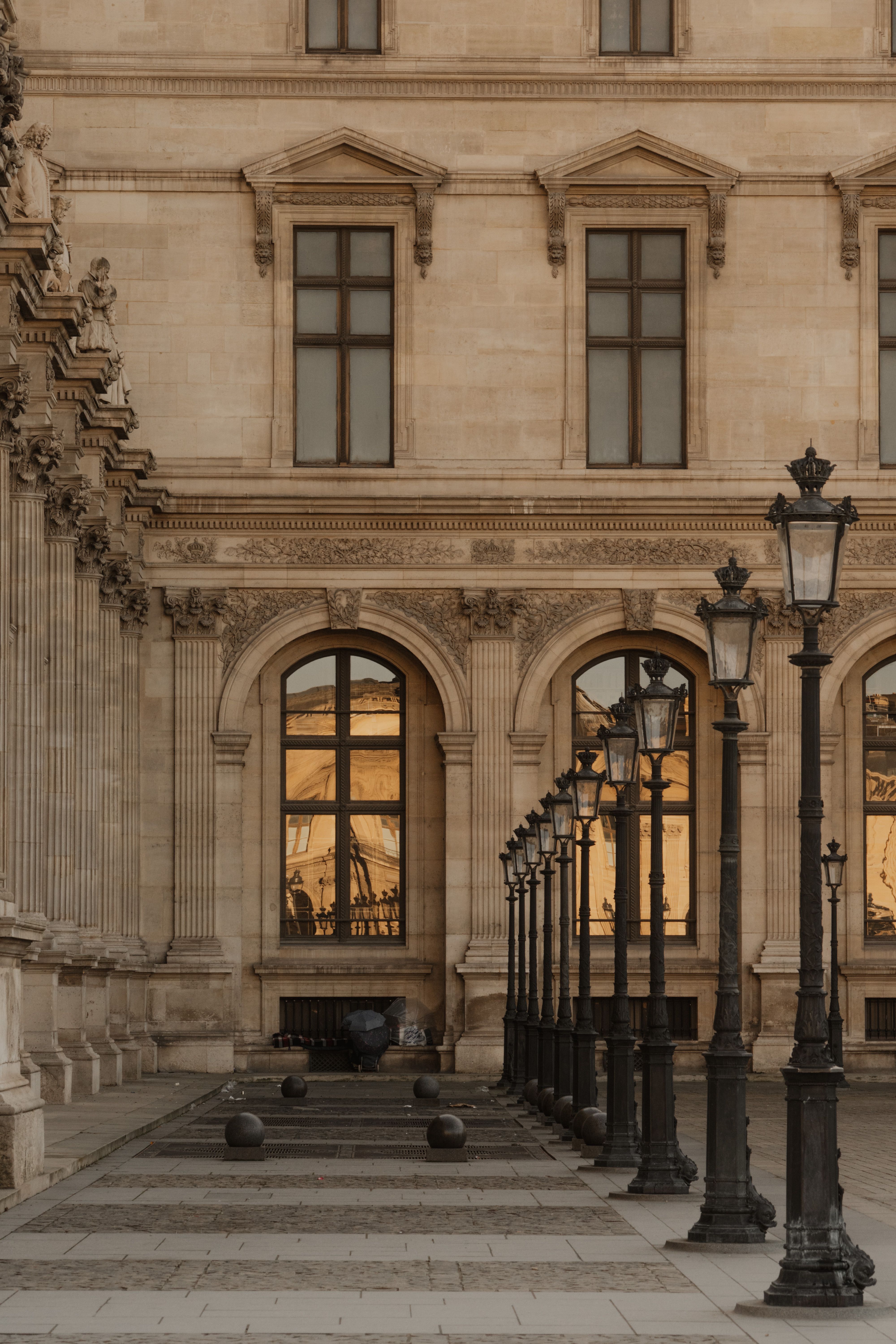 A classic view of the Louvre Museum in Paris showcasing its historic architecture and iconic design.