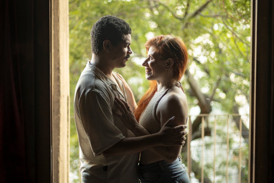 Como Praticar o Amor Próprio no Dia a Dia com Simplicidade 2 A loving couple sharing a tender moment by a doorway with natural light flowing in. Captured in Buenos Aires.