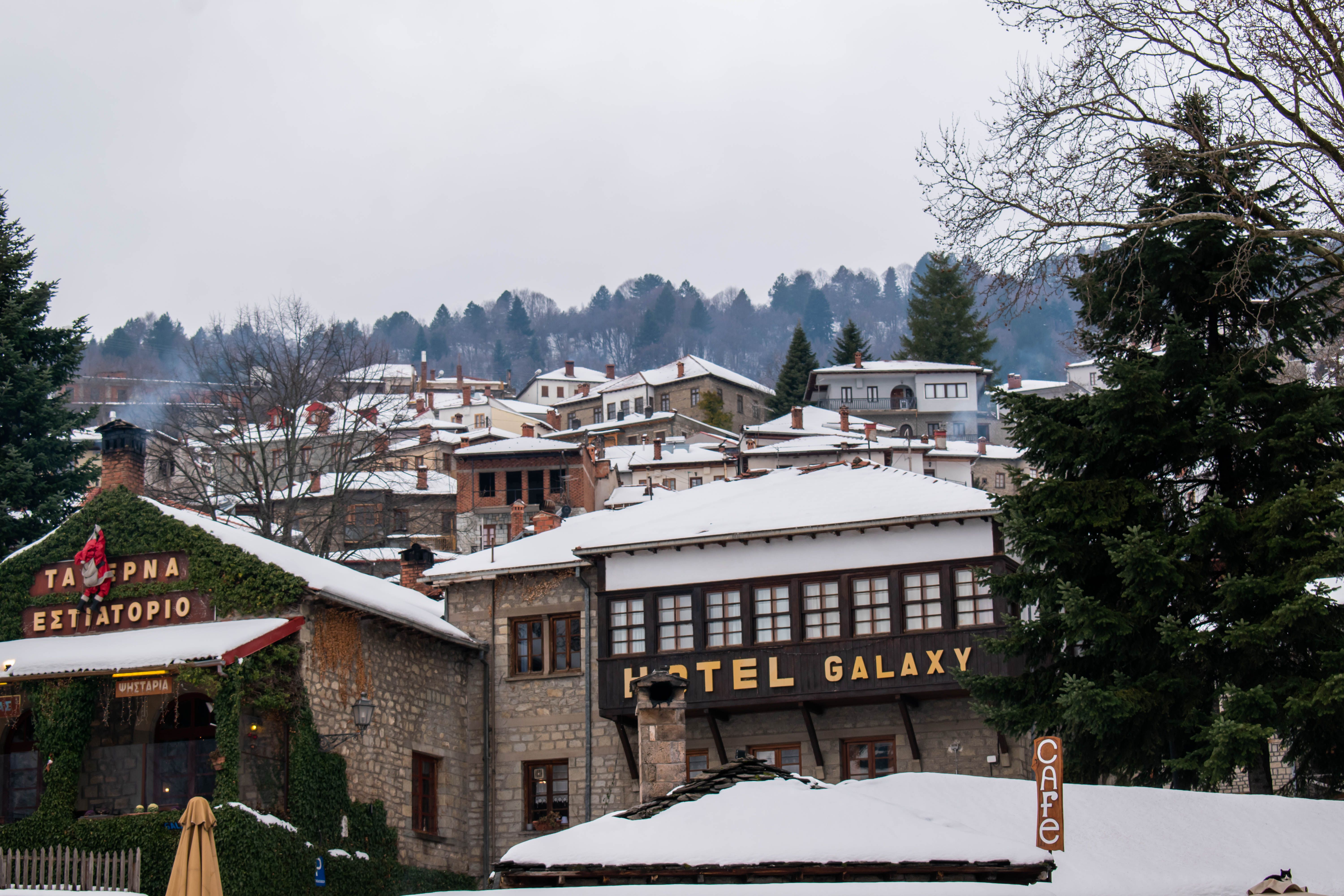 Charming winter view of Metsovo village with snowy rooftops and traditional architecture.