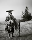 Traditional Andean Elder in Cusco Landscape