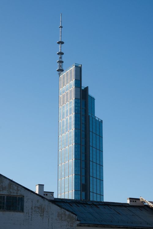 Free Contemporary skyscraper against a clear blue sky in Warsaw, Poland, showcasing architectural design. Stock Photo