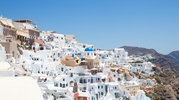 A captivating view of Santorini's iconic white buildings under a clear blue sky., free online jigsaw puzzle on JigsawPuzzlesFreeOnline.org