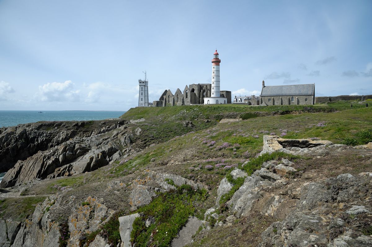 Rocky Brittany coastline with a lighthouse, ideal for bass fishing