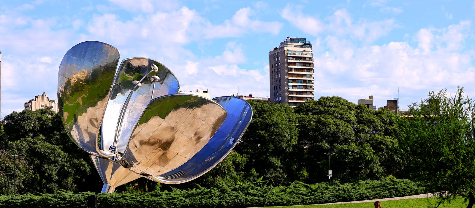 Floralis Generica sculpture in a Buenos Aires park with buildings in the background. — flights from Santiago to Buenos Aires