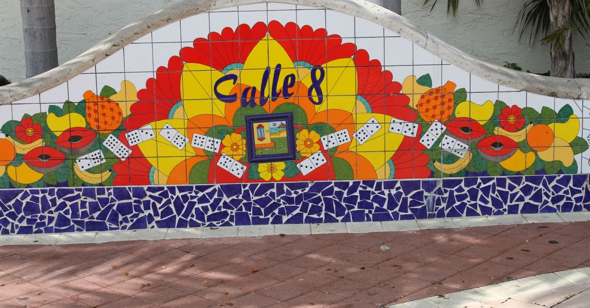 Vibrant mosaic mural in Little Havana, Miami featuring Calle 8 with colorful fruits and dominoes.