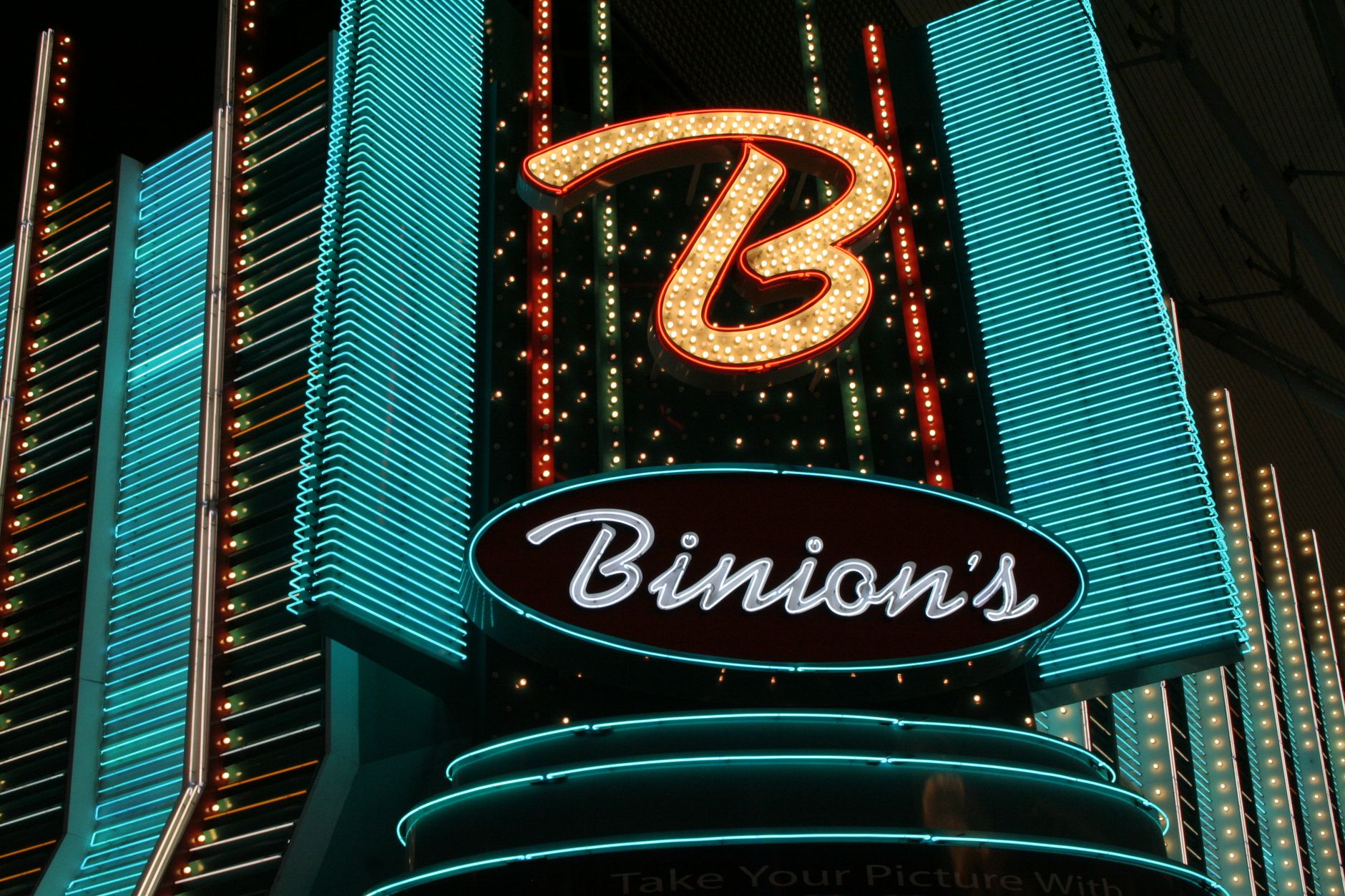 Vibrant neon lights illuminate the iconic Binion's Casino sign in Las Vegas.