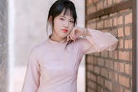 Elegant Portrait of Woman in Pink Ao Dai