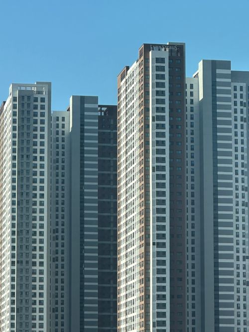 Free Tall skyscrapers with a modern design stand against a clear blue sky, showcasing urban architecture. Stock Photo