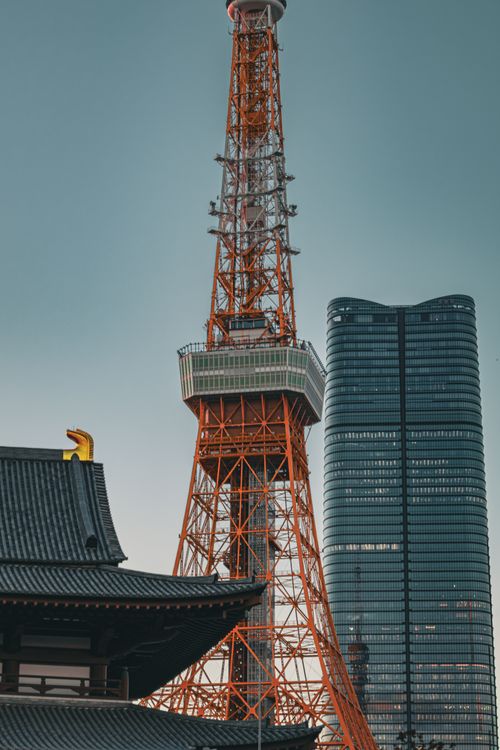 Free A striking view of Tokyo Tower alongside a modern skyscraper in Minato City, Tokyo. Stock Photo