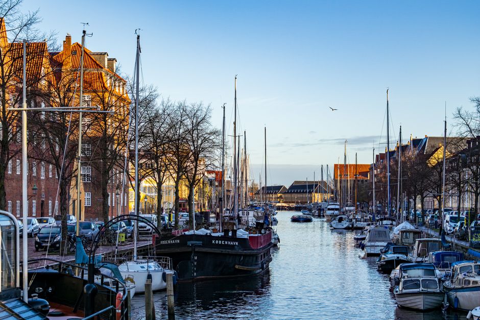 Colorful canal with boats in Christianshavn, Copenhagen captured on a sunny winter day.