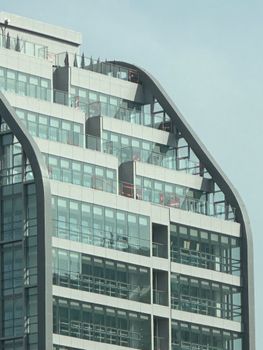 Close-up of a modern skyscraper showcasing its geometric glass and steel design.