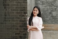Portrait of Woman in Traditional Dress by Brick Wall