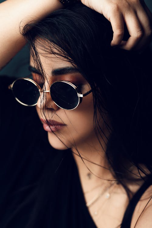 Close-up Photo Woman Wearing Black Framed Sunglasses with Her Hand on Her Head